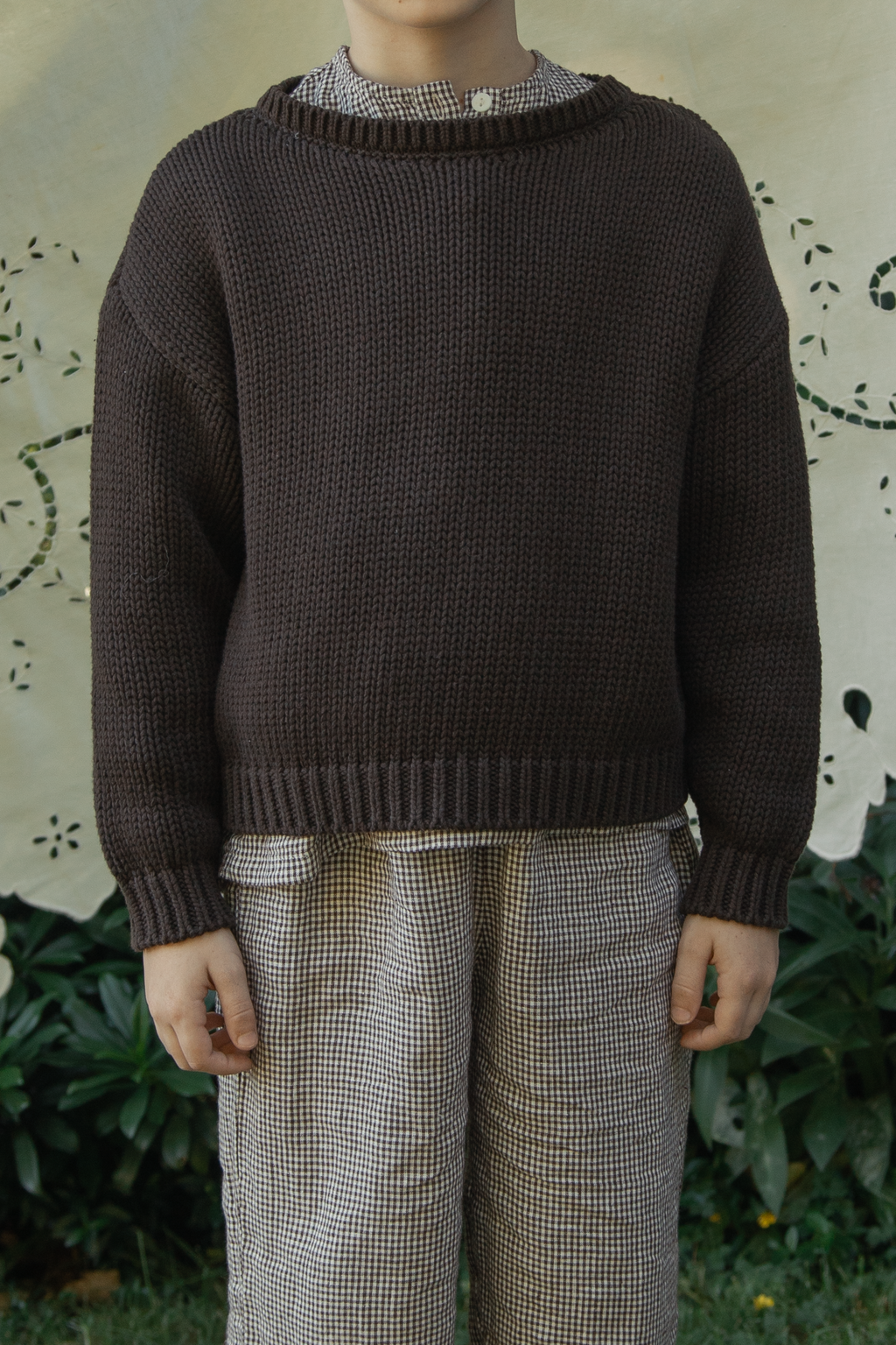 Child wearing the Mini Townes Pullover in Espresso by Gillian Stevens, front view showing chunky rib knit texture
