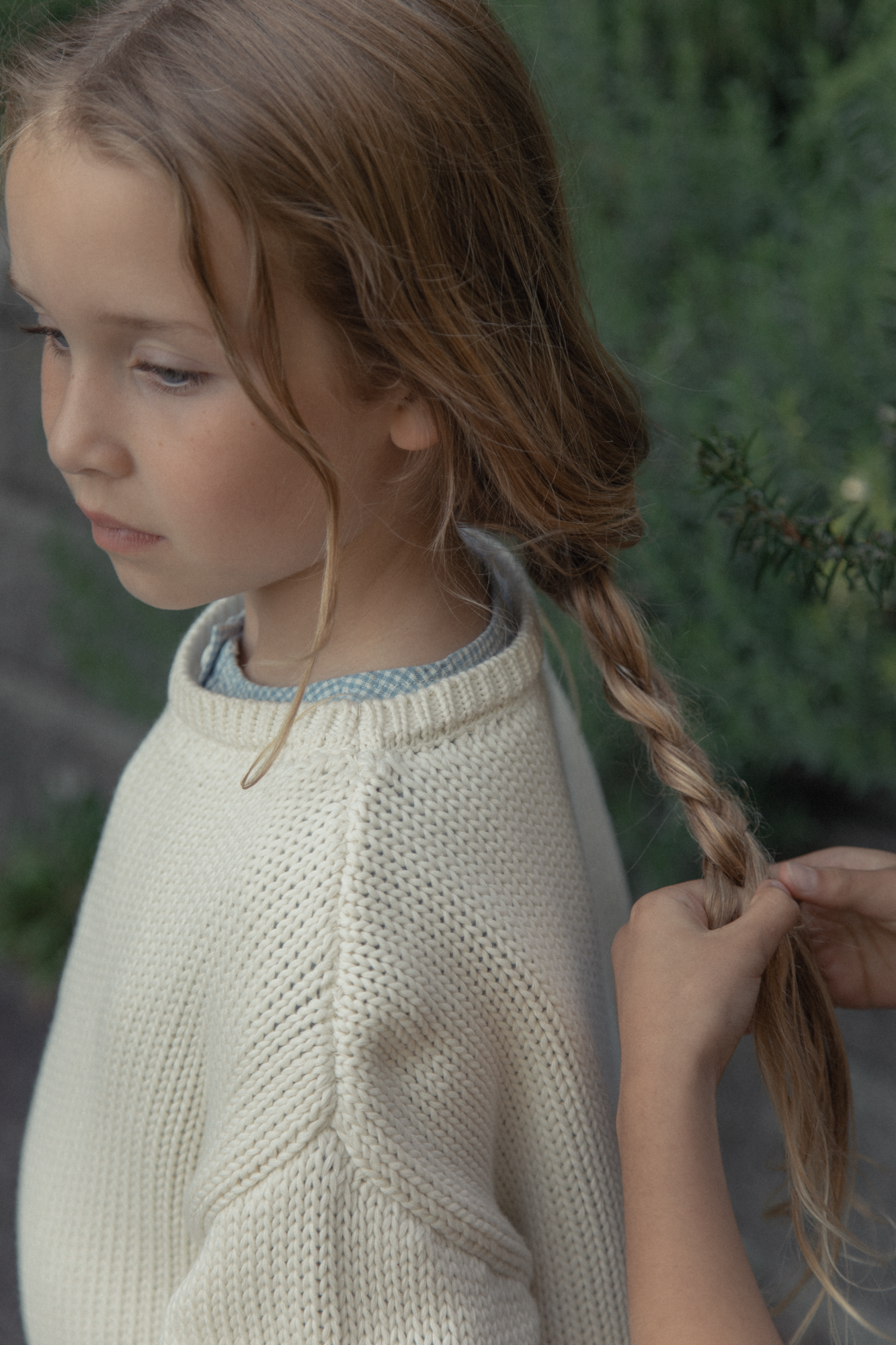Child wearing the Mini Townes Pullover in Alabaster by Gillian Stevens, front view showing textured knit detail