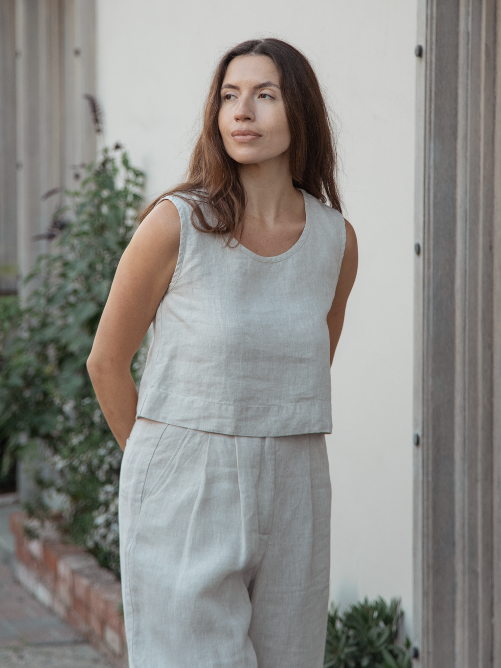 Model wearing the Eva Tank in Oatmeal by Gillian Stevens, front view in an outdoor setting