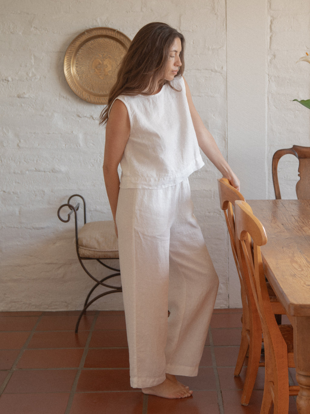Model wearing the Finley Pant in Salt by Gillian Stevens, front view in a warm interior setting