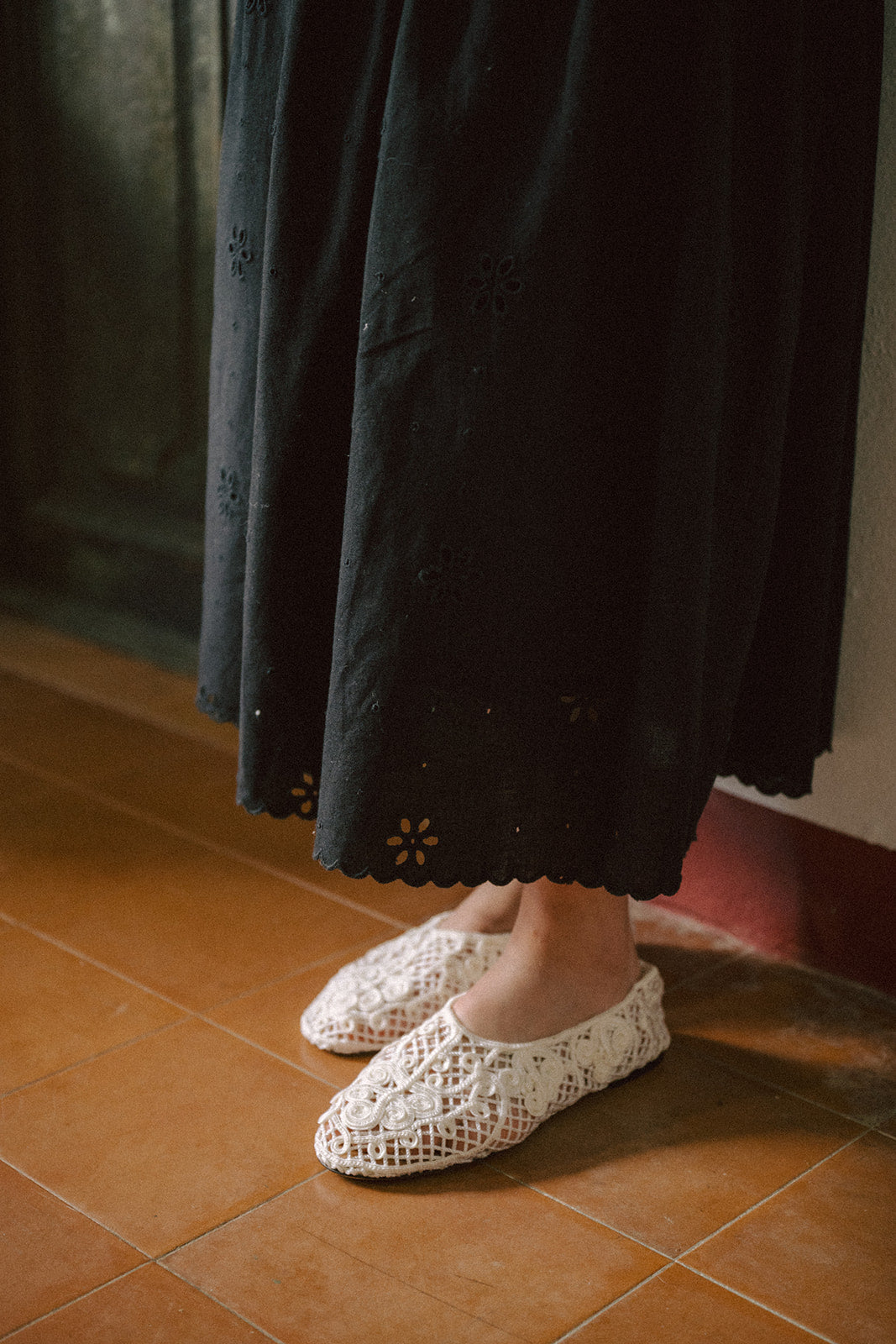 Detail shot of the Stella Skirt in Noir by Gillian Stevens, showing the scalloped broderie anglaise hem