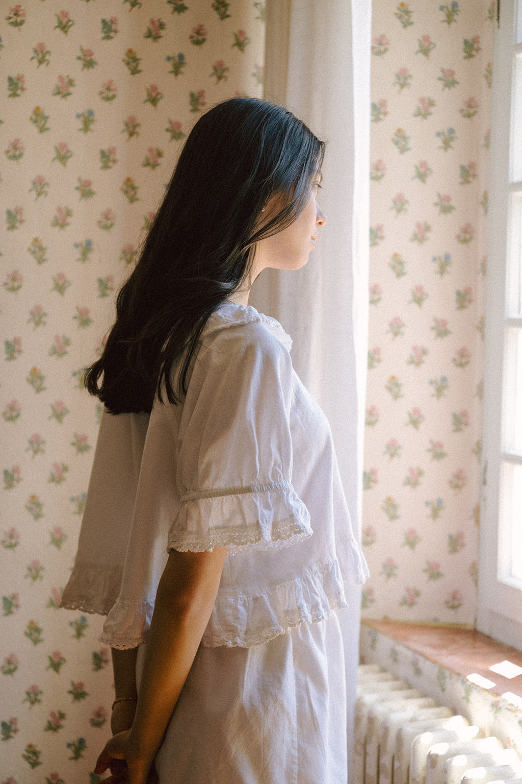 Model wearing the Arlette Top in Salt by Gillian Stevens, side view showing lace-trimmed bell sleeves