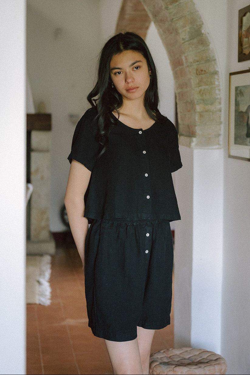 Model wearing the Wren Top in Noir by Gillian Stevens, front view styled with matching black shorts
