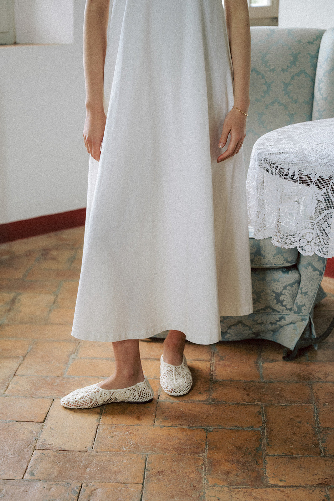 Model wearing the Palmer Dress in Salt by Gillian Stevens, cropped detail of hem and A-line skirt