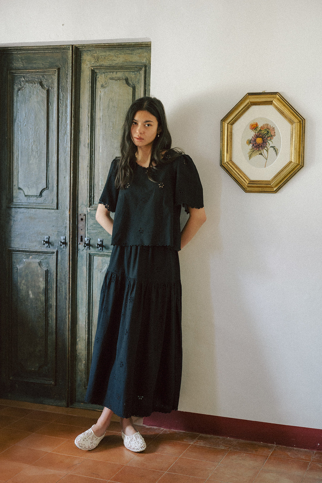 Model wearing the Stella Top in Noir by Gillian Stevens, front view styled with a matching black maxi skirt