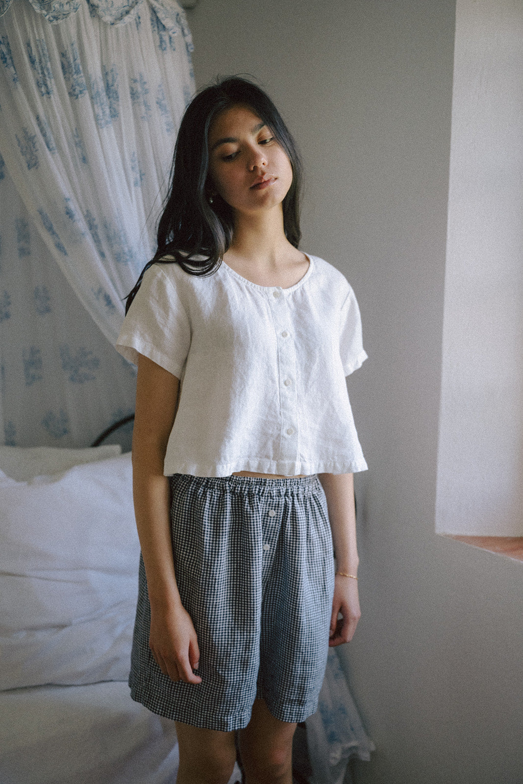 Model wearing the Wren Top in Salt by Gillian Stevens, front view styled with gingham shorts
